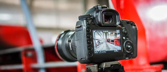 Photographer and videographer holding dslr camera and take photo or record video clip. Selective focus