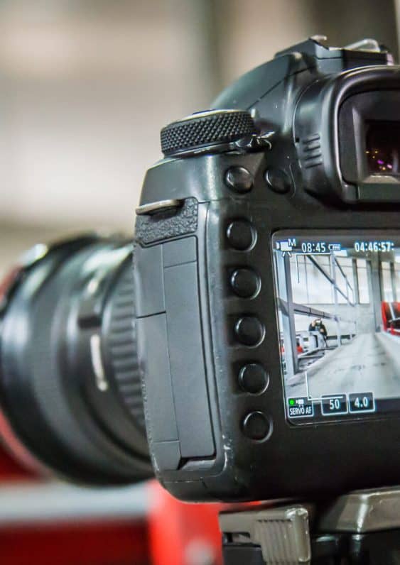 Photographer and videographer holding dslr camera and take photo or record video clip. Selective focus